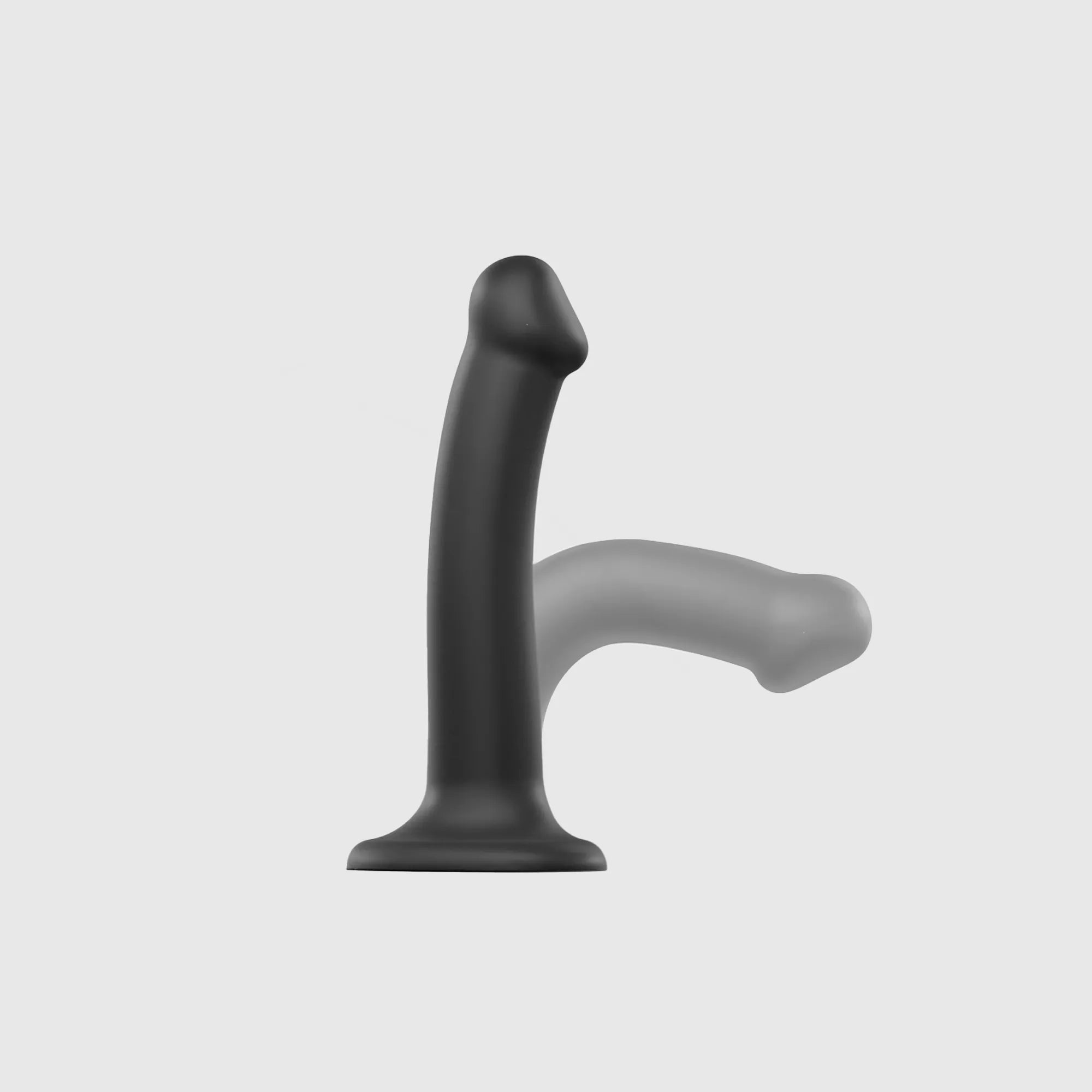 Gode en silicone strap-on, démontrant sa souplesse et son noyau à double densité.