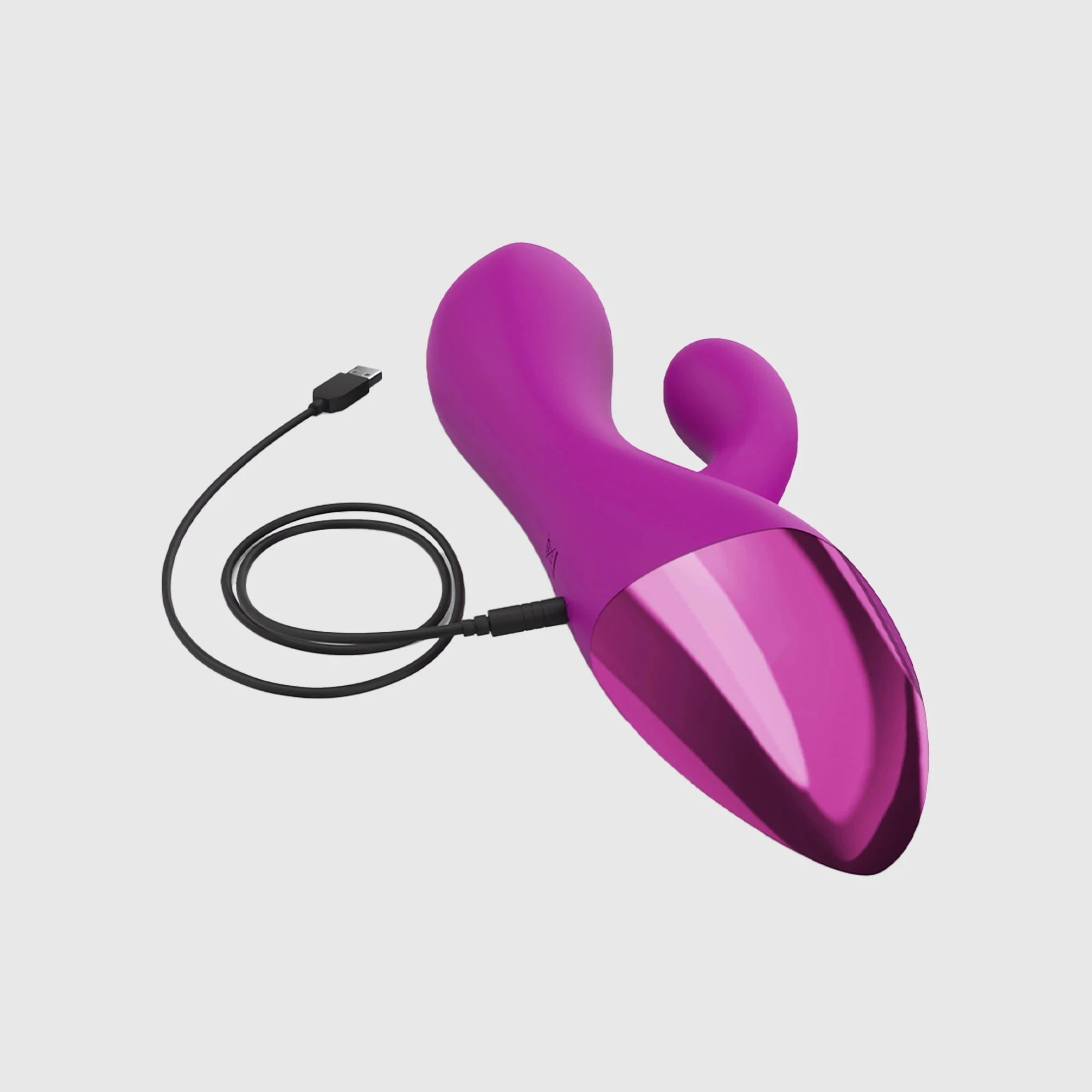 Vibromasseur rabbit flexible double stimulation Funky Bunny en silicone rose avec finition métallisée, branché à son câble de recharge USB.